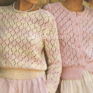 May include: Two knitted jumpers, one in a cream colour with a pink diamond pattern and the other in a pink colour with a white diamond pattern. Both jumpers have long sleeves and a round neckline.