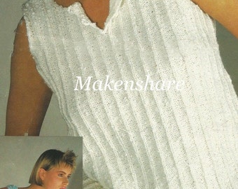 May include: A white sleeveless knitted top with a V-neck and a ribbed texture. The top is worn by a model with short hair and is paired with a floral skirt.