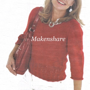 May include: A red knit sweater with three-quarter sleeves and a decorative hem. The image also shows a red leather handbag and the text "Makenshare". The woman is wearing a silver necklace and earrings.