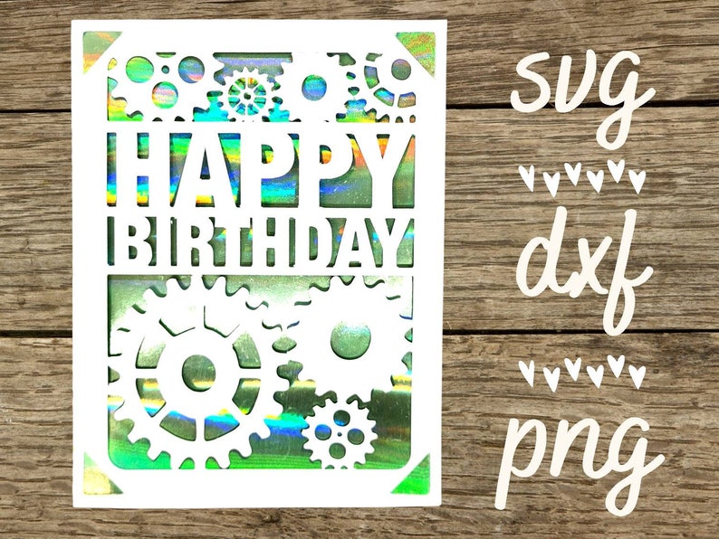 May include: A white card with a holographic background featuring the words "Happy Birthday" surrounded by gears. The card is on a wood background with the words "svg", "dxf", and "png" written in white.