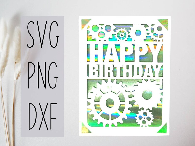 May include: White card with a holographic background and a cut-out design of gears and the words "Happy Birthday".