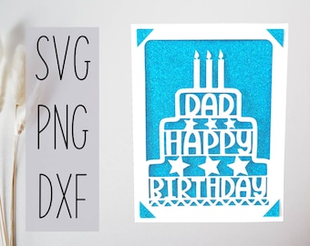 May include: A white paper card with a blue glitter background. The card features a white silhouette of a cake with candles and the text "Dad Happy Birthday".
