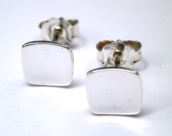 May include: A pair of silver square stud earrings. The earrings are simple and elegant, and they would make a great gift for any occasion.