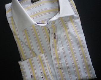 May include: A striped dress shirt with a white collar and yellow, red, and white stripes. The shirt has a purple trim around the collar and cuffs. The label on the shirt reads "J.M. Weston London".