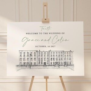 May include: A wedding welcome sign on an easel. The sign features the words "Welcome to the Wedding of Grace and Colin" and the date "October 16, 2027." A detailed black and white illustration of a building is at the bottom of the sign.