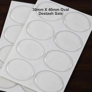 May include: A sheet of clear, adhesive oval-shaped stickers arranged in a grid pattern on a white backing. The text 30mm X 40mm Oval Destash Sale is printed in black at the top of the sheet. Each sticker has a smooth, glossy, transparent surface.