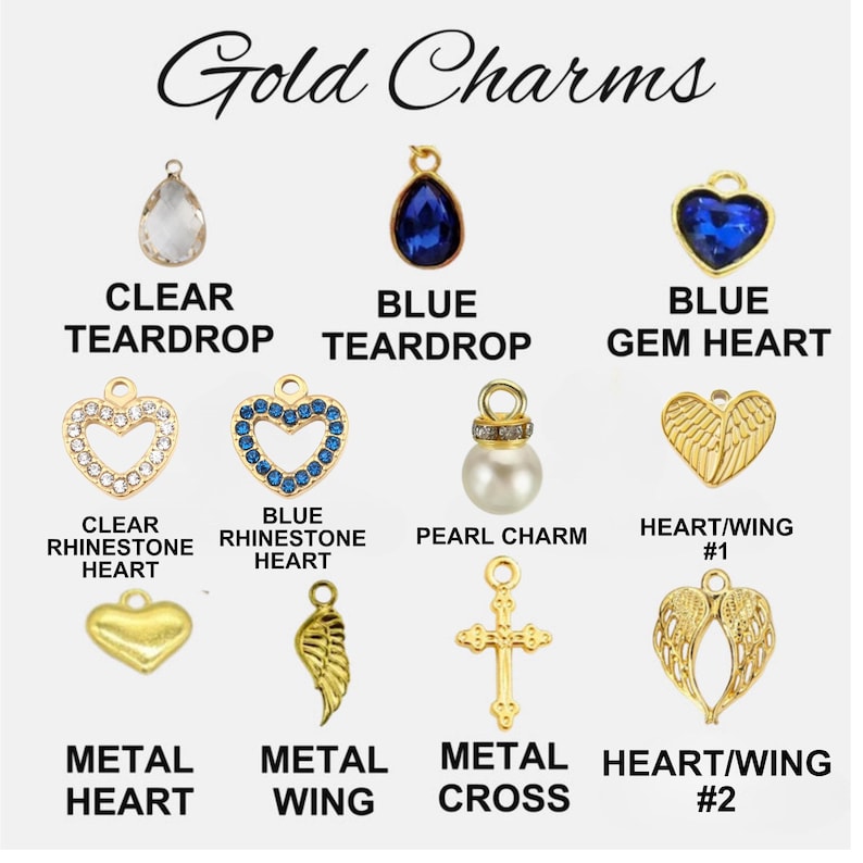 May include: A collection of gold charms labeled Gold Charms, including a clear teardrop, blue teardrop, blue gem heart, clear rhinestone heart, blue rhinestone heart, pearl charm, heart wing, metal heart, metal wing, metal cross, and heart wing.