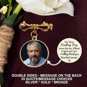 May include: A gold-toned brooch featuring a bow-shaped pin at the top and a circular pendant hanging below. The pendant displays a photograph of a man with a beard on one side and the text, On Your Wedding Day know that my Heart is there and I am walking beside you. Know that I am near, on the other side.