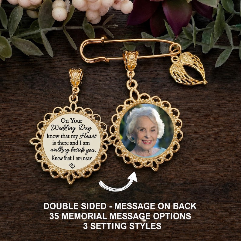May include: A gold-toned brooch pin featuring a dangling circular pendant with a scalloped edge. One side displays a photograph of an older woman, while the other side features the text: On Your Wedding Day know that my Heart is there and I am walking beside you. Know that I am near. A small angel wing charm is attached.