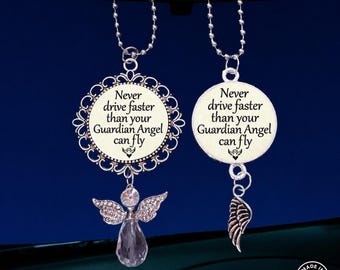 May include: Two silver-toned car charms hanging from ball chains. Each charm features a round pendant with the text 'Never drive faster than your Guardian Angel can fly' and a small angel icon. One pendant has a filigree border and crystal angel.