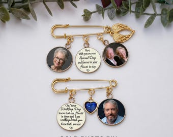 May include: Two gold-toned safety pins featuring dangling charms. The top pin has two circular photo charms and a central disc with the text "Here with you on your Special Day and forever in your Heart to stay". The bottom pin has a blue heart charm, a photo charm, and a disc with the text "On your Wedding Day know that my Heart is there and I am walking beside you".