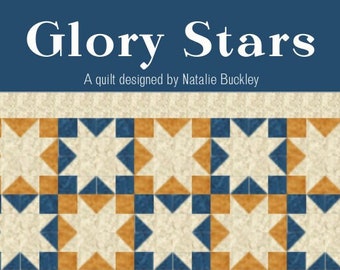 May include: A quilt titled Glory Stars designed by Natalie Buckley featuring a repeating star pattern in cream, navy blue, and mustard yellow. The design consists of geometric blocks arranged in a grid with a cream border surrounding the entire piece.