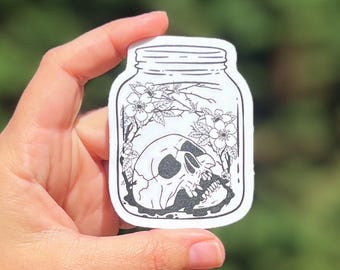 Skull in a Jar Vinyl Sticker – Gothic Floral Skeleton Decal - Waterproof Die Cut Sticker for Laptop, Journal, Water Bottle, or Spellbook