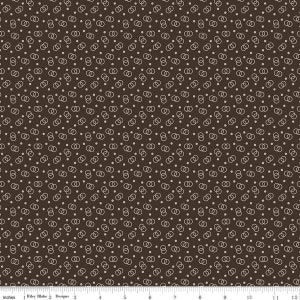 May include: A brown fabric with a repeating pattern of white interlocking circles and small white dots.