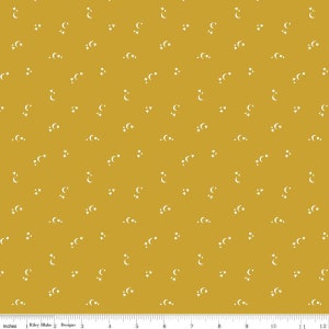 May include: A yellow fabric with a white repeating pattern of crescent moons and stars.