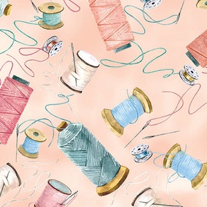 May include: A collection of colorful spools of thread with different textures and colors, including pink, blue, white, and green. The spools are arranged on a light pink background.