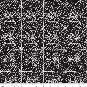 Pode incluir: Tecido preto e branco com um padrão repetido de teias de aranha.