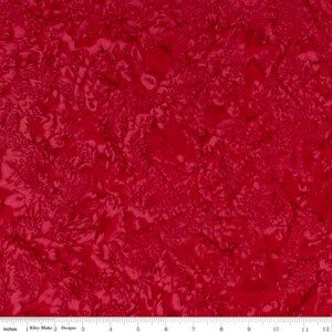 May include: Red fabric with a swirling, abstract pattern. The fabric has a subtle sheen and a soft, smooth texture.