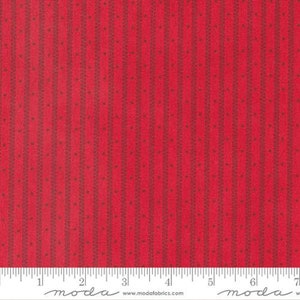 May include: Red fabric with a repeating pattern of vertical stripes and small dots. The fabric is measured with a ruler that reads "moda" and includes the website address "www.modafabrics.com".