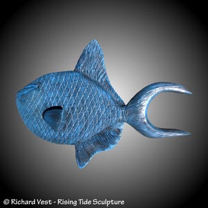 May include: A blue, wooden sculpture of a triggerfish. The fish is carved with detailed scales and fins. The sculpture is a realistic representation of a triggerfish.