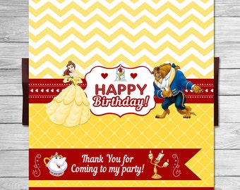 May include: A yellow and red birthday party favor bag with a chevron pattern. The bag features Belle and the Beast from Beauty and the Beast. The text on the bag reads "Happy Birthday!" and "Thank You for Coming to my Party!"
