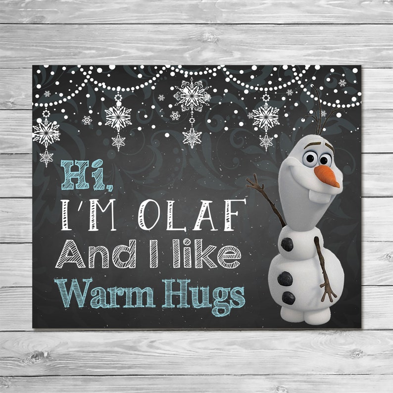 May include: A black chalkboard with a white border and a white snowflake design. The text "Hi, I'm Olaf And I like Warm Hugs" is written in white chalk. A cartoon image of Olaf from the movie Frozen is on the right side of the board.