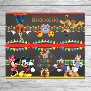 May include: A colorful birthday party banner featuring Disney characters like Mickey Mouse, Minnie Mouse, Donald Duck, and Goofy. The banner has the text "Happy Birthday!" and "Oh Toodles! Thanks for coming!" on a dark gray background with decorative elements.