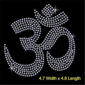 May include: A silver Om symbol made of rhinestones on a black background. The symbol is 4.7 inches wide and 4.8 inches long.