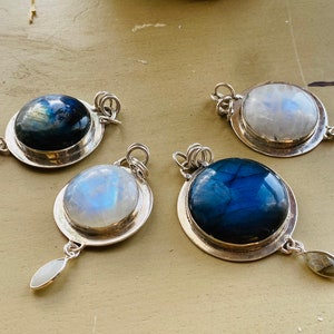 "Embrace Earthkarmajewellery's Handmade Labradorite Necklace, reminiscent of a round blue moon in the cosmic expanse, beautifully set in sterling silver, for a bohemian flair with a moonstone dangle."
