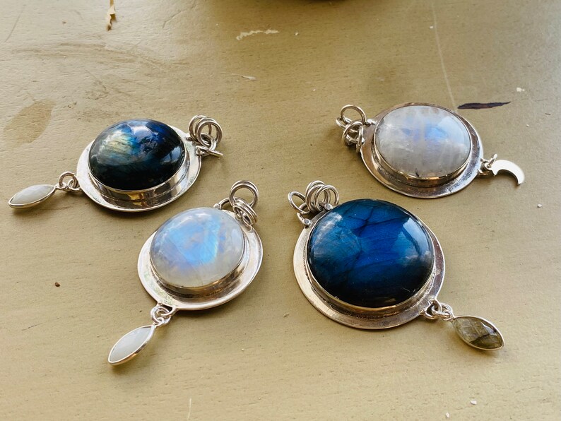 "Embrace Earthkarmajewellery's Handmade Labradorite Necklace, reminiscent of a round blue moon in the cosmic expanse, beautifully set in sterling silver, for a bohemian flair with a moonstone dangle."