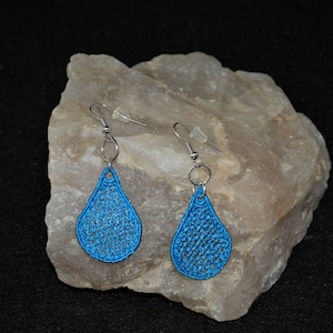 May include: A pair of teardrop-shaped earrings with a blue crocheted design and silver hooks.