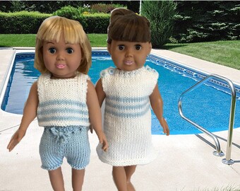 May include: Two dolls wearing knitted outfits stand by a swimming pool. The doll on the left is wearing a white and blue striped tank top and blue shorts. The doll on the right is wearing a white and blue striped dress.