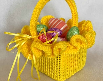May include: A yellow crocheted Easter basket with a ruffled edge and a yellow ribbon. The basket is filled with colorful Easter eggs.