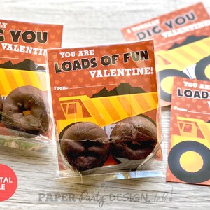 May include: A set of printable Valentine's Day cards featuring a cartoon dump truck with the text "Totally Dig You Valentine!" and "You Are Loads of Fun Valentine!" The cards are printed on red paper with white hearts and yellow and orange accents.