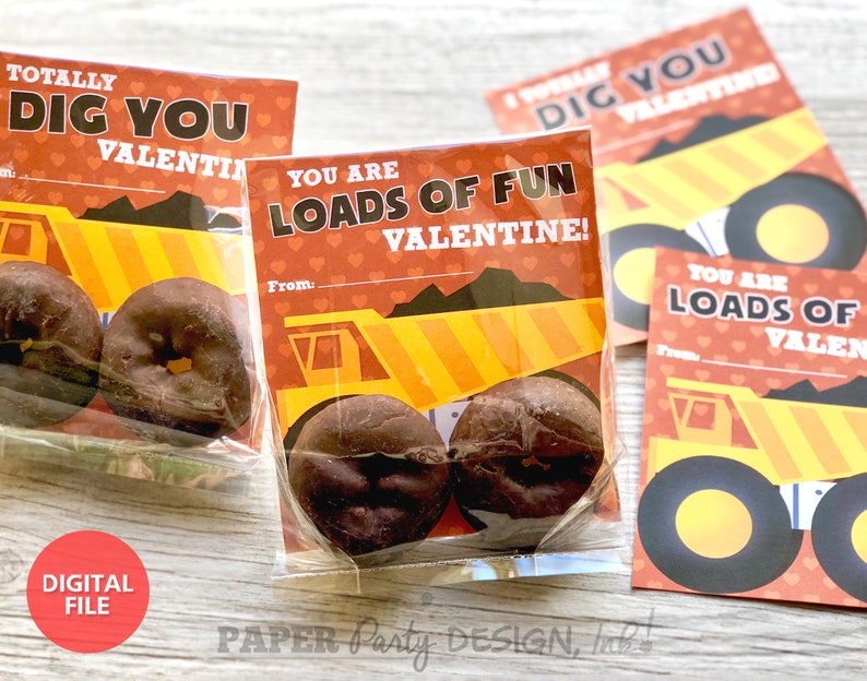 May include: A set of printable Valentine's Day cards featuring a cartoon dump truck with the text "Totally Dig You Valentine!" and "You Are Loads of Fun Valentine!" The cards are printed on red paper with white hearts and yellow and orange accents.
