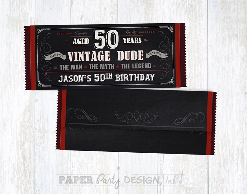 May include: A black and red chocolate bar wrapper with a chalkboard design. The wrapper says "Premium Aged 50 Years Vintage Dude Edition" and "The Man The Myth The Legend". It also says "Jason's 50th Birthday".