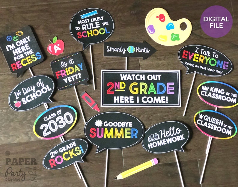 May include: A set of 12 printable photo booth props for a second grade graduation party. The props feature colorful speech bubbles with phrases like "Watch Out 2nd Grade Here I Come!" and "2nd Grade Rocks!"