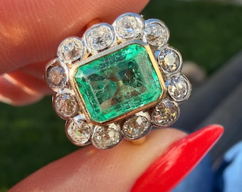 Antique natural emerald and old European cut diamond halo ring in 18 karat yellow gold