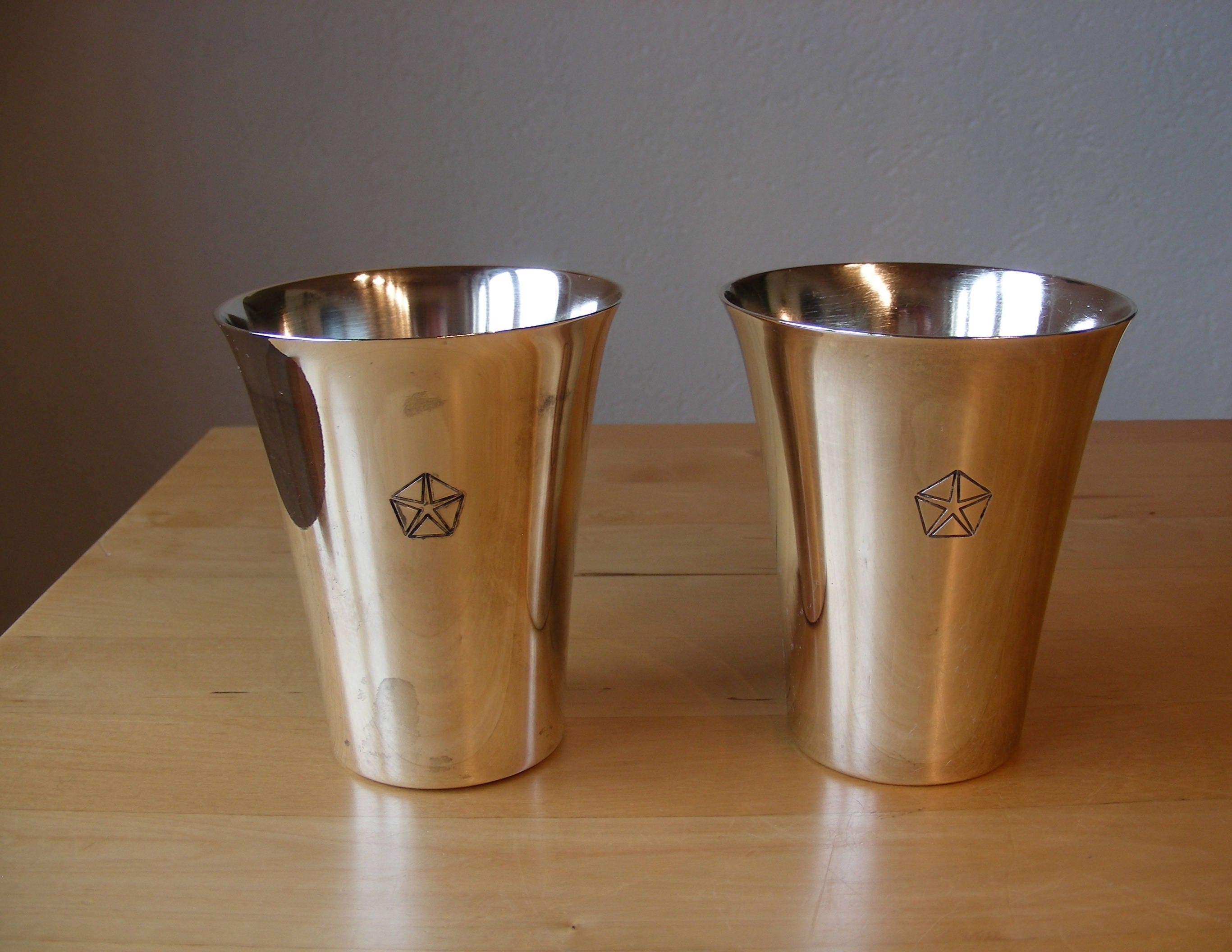 Two simple silver plated cups marked H. Beard on bottom, symbol on side