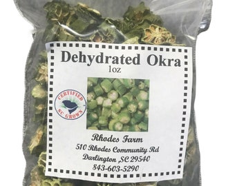 May include: A clear plastic bag filled with dehydrated okra. The bag has a label that reads "Dehydrated Okra 1 oz" and includes the farm's name, address, and phone number. The label also has a "Certified SC Grown" logo.