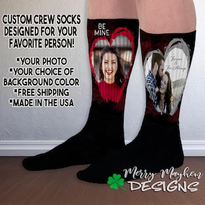 May include: A pair of black crew socks with a red heart design. The heart features a photo of a couple and the text "Be Mine" and "Forever & For Always".