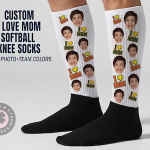 May include: White knee socks with black cuffs featuring a repeating pattern of a woman's face, the words "I LOVE MOM", and a softball graphic. The text "CUSTOM I LOVE MOM SOFTBALL KNEE SOCKS" is displayed in blue.