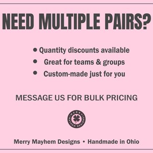 May include: A light pink rectangular graphic with dark text reading NEED MULTIPLE PAIRS? followed by bullet points about quantity discounts, teams, groups, and custom orders. It includes MESSAGE US FOR BULK PRICING, a circular Merry Mayhem Designs logo, and Merry Mayhem Designs &bull; Handmade in Ohio.