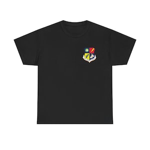 May include: Black t-shirt with a colorful emblem on the left chest. The emblem features a shield design with a lightning bolt, a globe, and text. The shirt is made of a soft material.