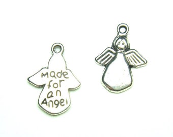 May include: Two silver-colored angel charms. One charm has the text "made for an angel". The other charm is a detailed angel with wings. Both charms have a small loop at the top for attaching to jewelry or crafts.