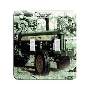 May include: A green and white John Deere 4301 tractor with a vintage aesthetic, surrounded by old newspaper clippings and advertisements. The tractor has two toggle switches labeled "OFF".