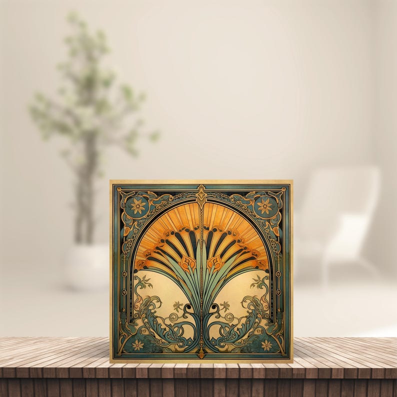 May include: Square art print with an Art Nouveau design. The print features a fan-shaped floral design in shades of gold, teal, and cream, framed by a teal border with floral accents. The artwork is displayed on a wooden surface.