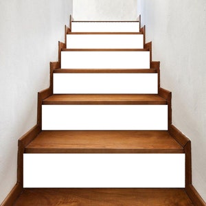 May include: A set of white stair treads with a wood base. The treads are designed to cover the existing steps and add a modern touch to the staircase.
