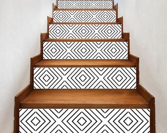 May include: Black and white geometric patterned stair treads. The pattern is a series of overlapping diamonds.
