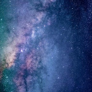 May include: A dark blue night sky with a bright, white Milky Way galaxy stretching across the frame. The galaxy is filled with a variety of stars, creating a beautiful and awe-inspiring scene.